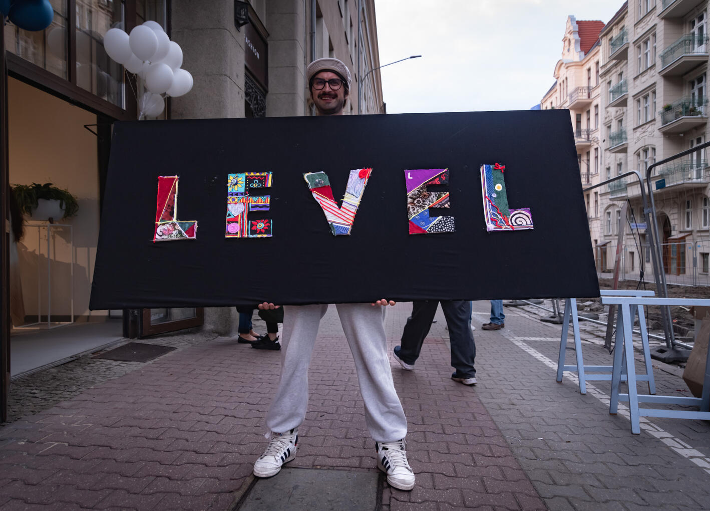 Upcyclingowy szyld stworzony z przechodniami podczas otwarcia butiku LEVEL